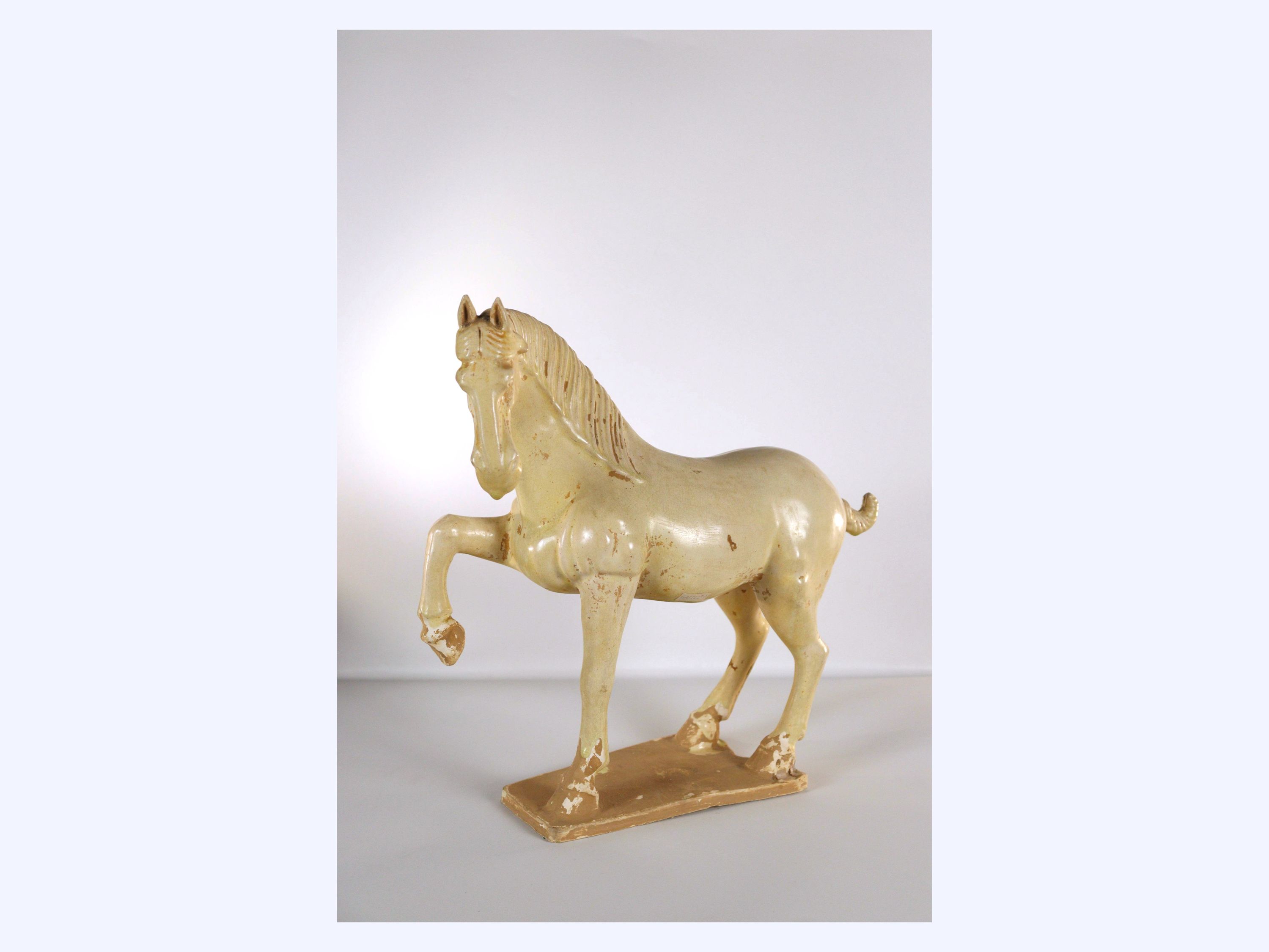 A Glazed Pottery Figure of a Prancing Horse